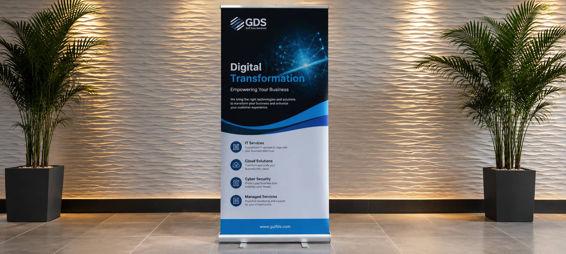 A vertical GDS branded roll-up banner stand displaying 'Digital Transformation' in a modern lobby with a textured beige wall, warm lighting, and potted plants on both sides.