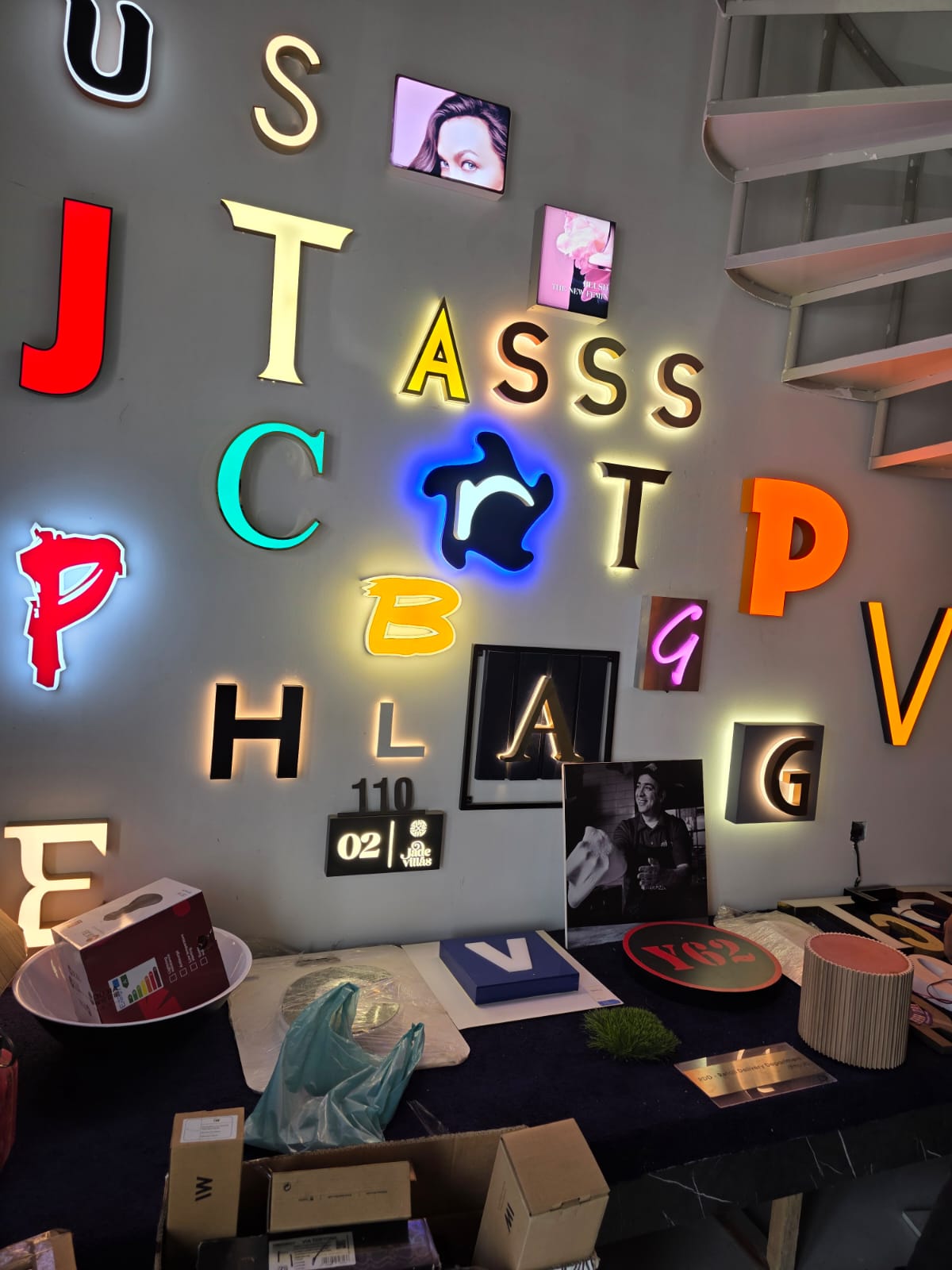 Showroom wall displaying various colorful backlit letters and logos built by Formset Advertising in different LED colors and styles