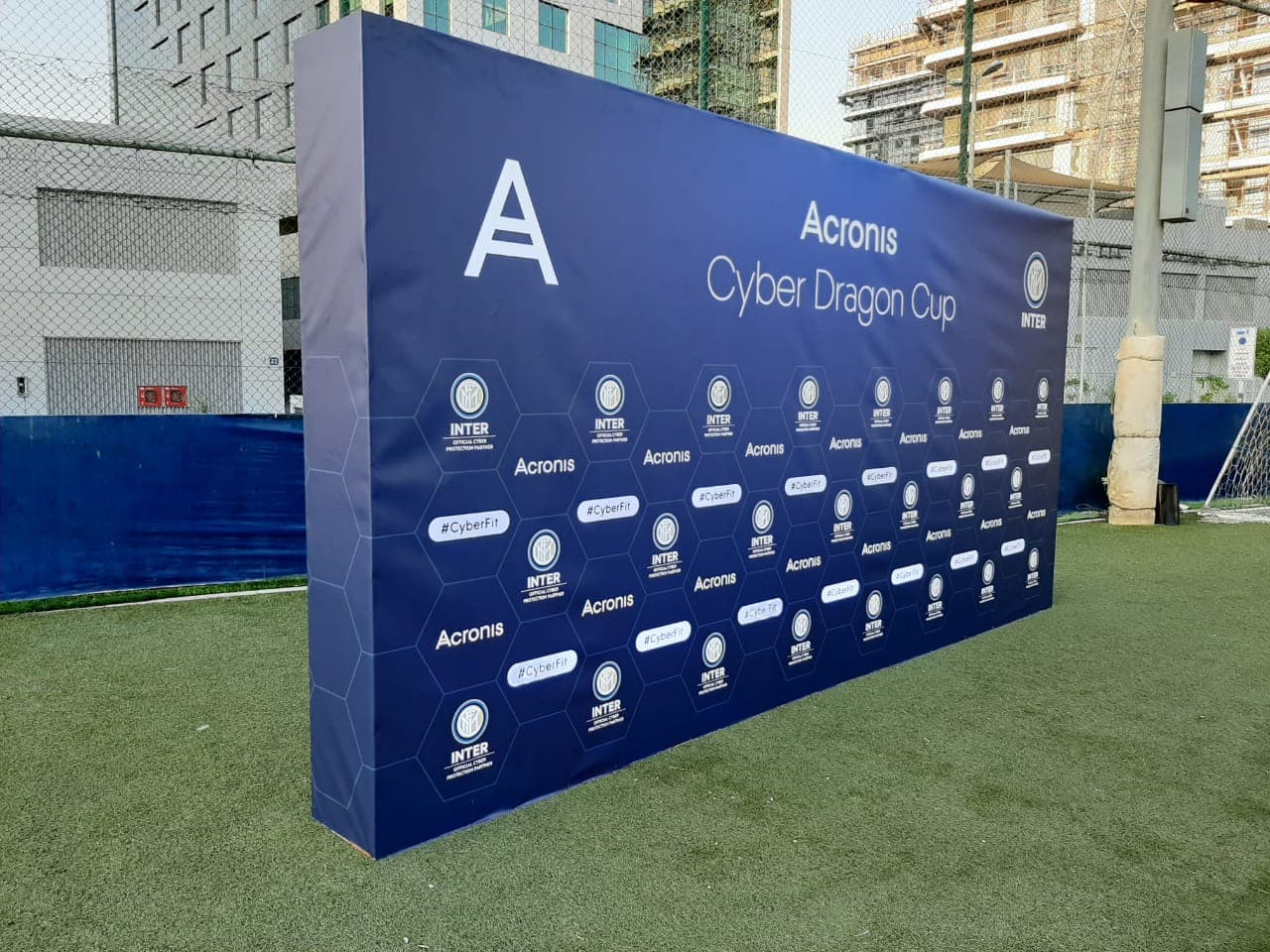 Large outdoor freestanding step and repeat media wall printed with sponsor logos for the Acronis Cyber Dragon Cup by Formset Advertising.