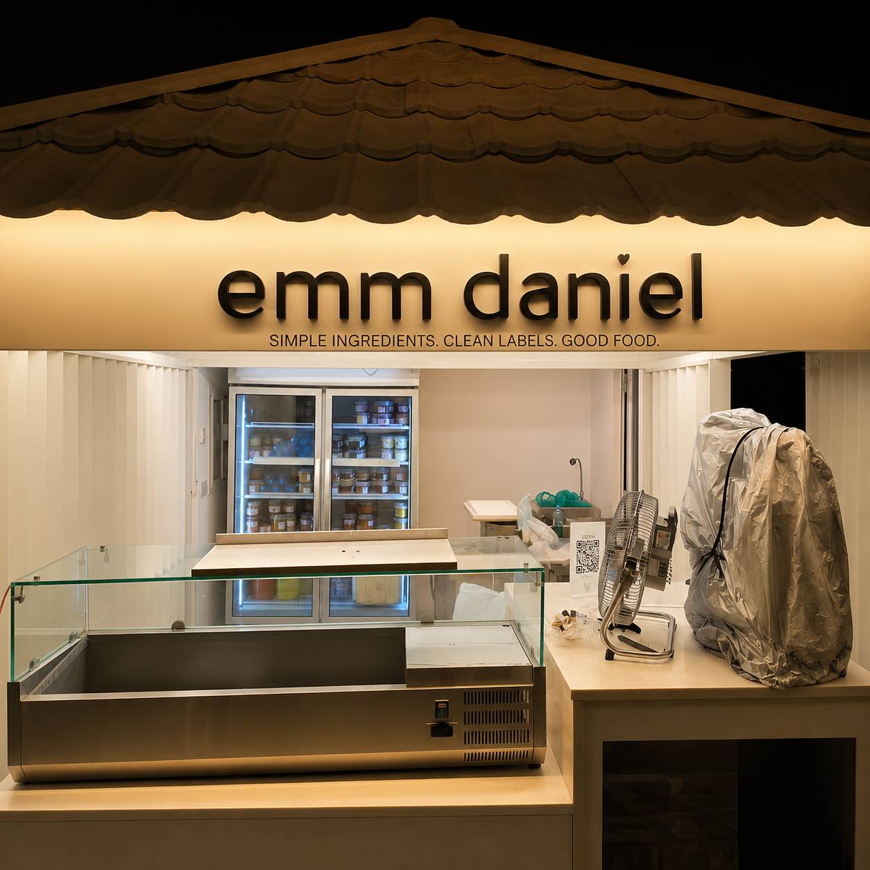 Custom white wooden 3D letters for emm daniel food brand installed on an outdoor platform