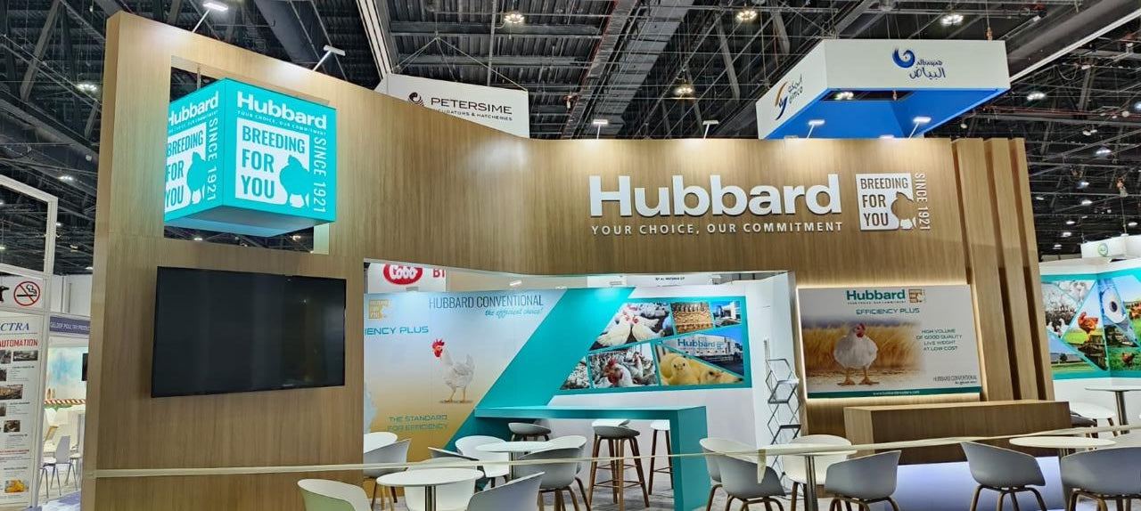 Large Hubbard cutout letters with tagline mounted on wood grain exhibition booth wall built by Formset Advertising in the UAE